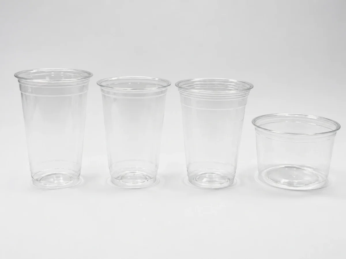 Clear PLA cold cups illustrating a plastic-looking material that should not enter conventional PET or PP recycling